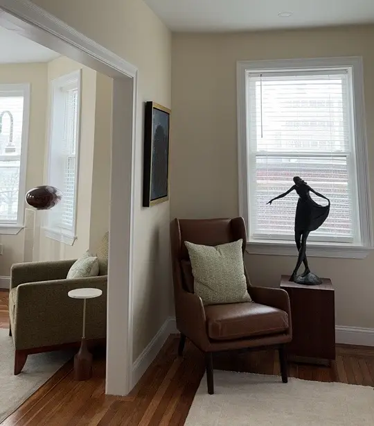 A living room filled with furniture and a statue